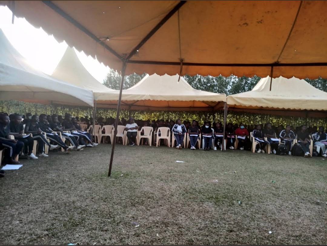 Delegates seated under a marquee for a seminar
