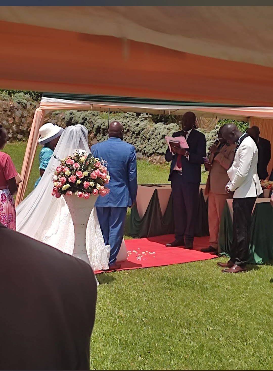 A garden wedding ceremony under marquees on the lawns